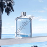 Jaguar Classic perfume bottle with a scenic background of palm trees and ocean.