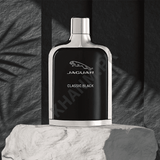 Jaguar Classic Black perfume bottle on a textured surface with a dark background