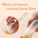 Bottle with a micro pressure control feature for food flow, held by a hand.