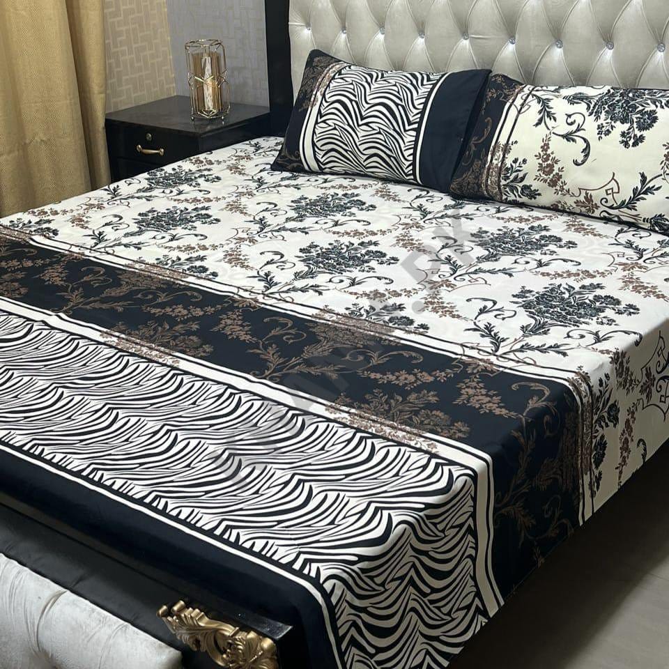 Bed with floral and zebra print bedding in a bedroom setting.