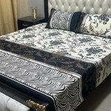 Bed with floral and zebra print bedding in a bedroom setting.