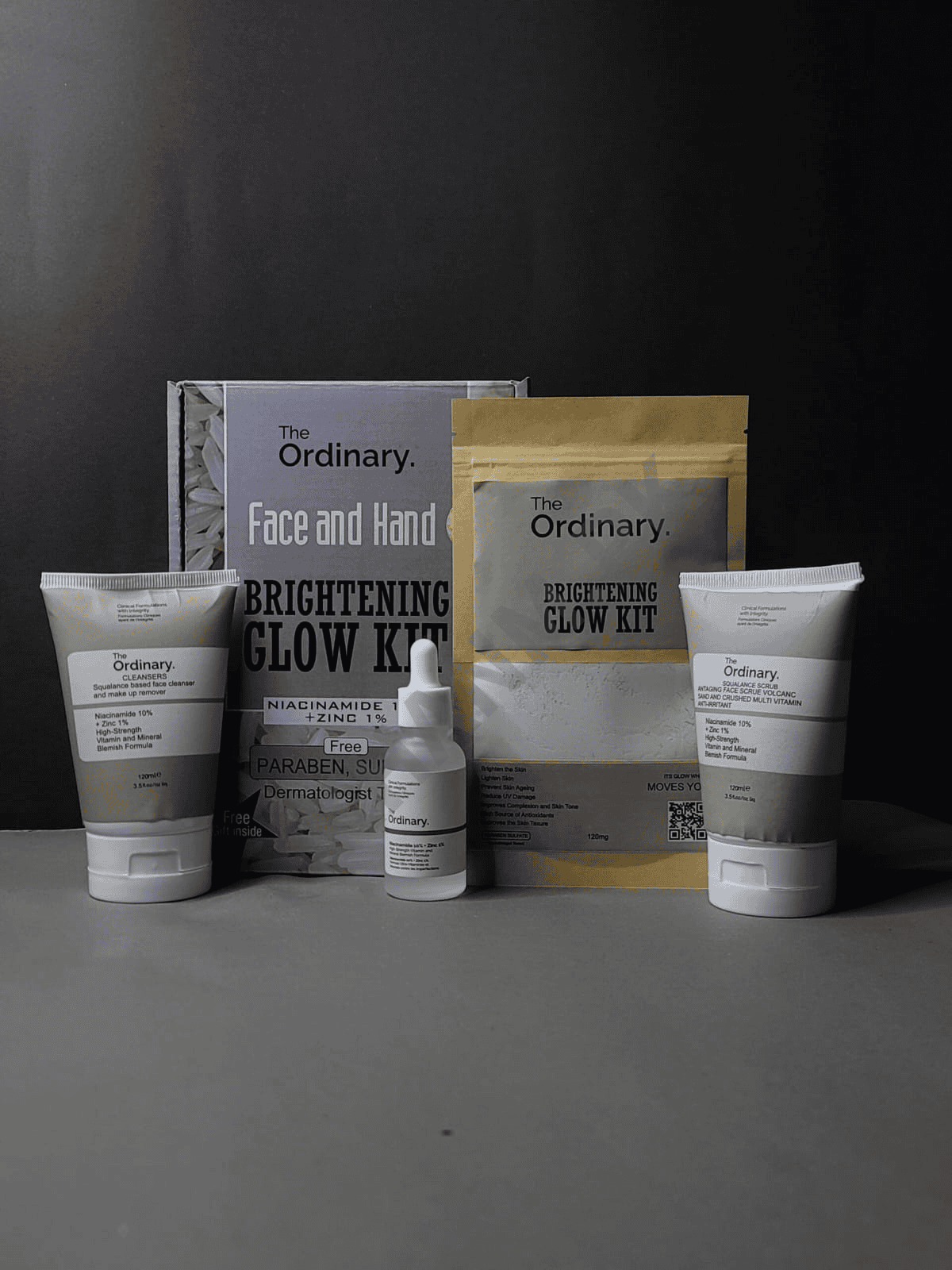 The Ordinary skincare products including face and hand cream, serum, and packaging on a dark background