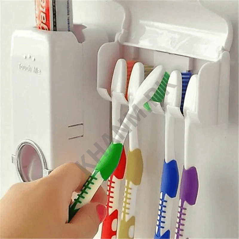 Colorful toothbrushes in a holder with a hand holding one, against a white background.