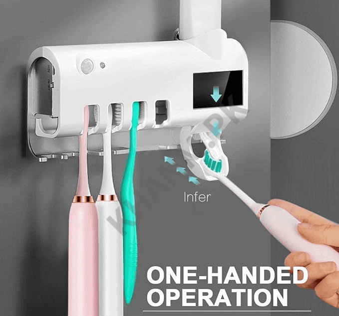 Electric toothbrush holder with toothbrushes and a hand using one, mounted on a gray wall.