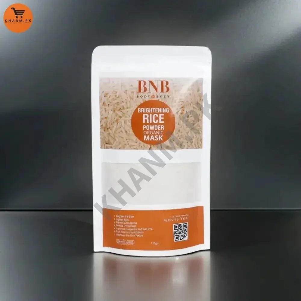 BNB Brightening Rice Powder Mask packaging on a reflective black surface with a dark background
