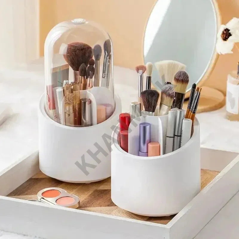 White cylindrical makeup organizers with brushes and lip products on a vanity.