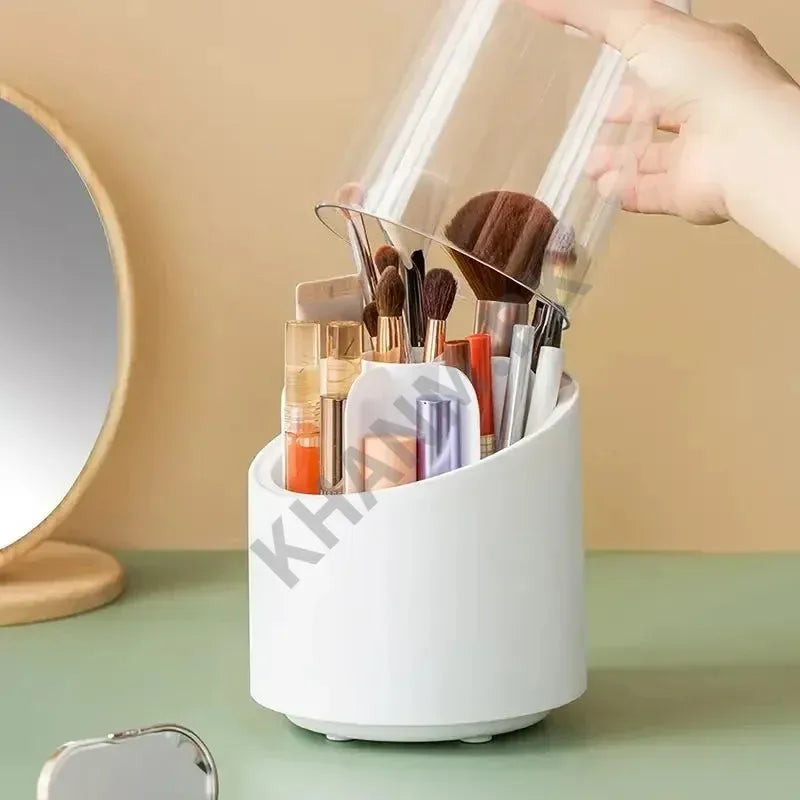 White makeup brush holder with various brushes and containers on a green surface.